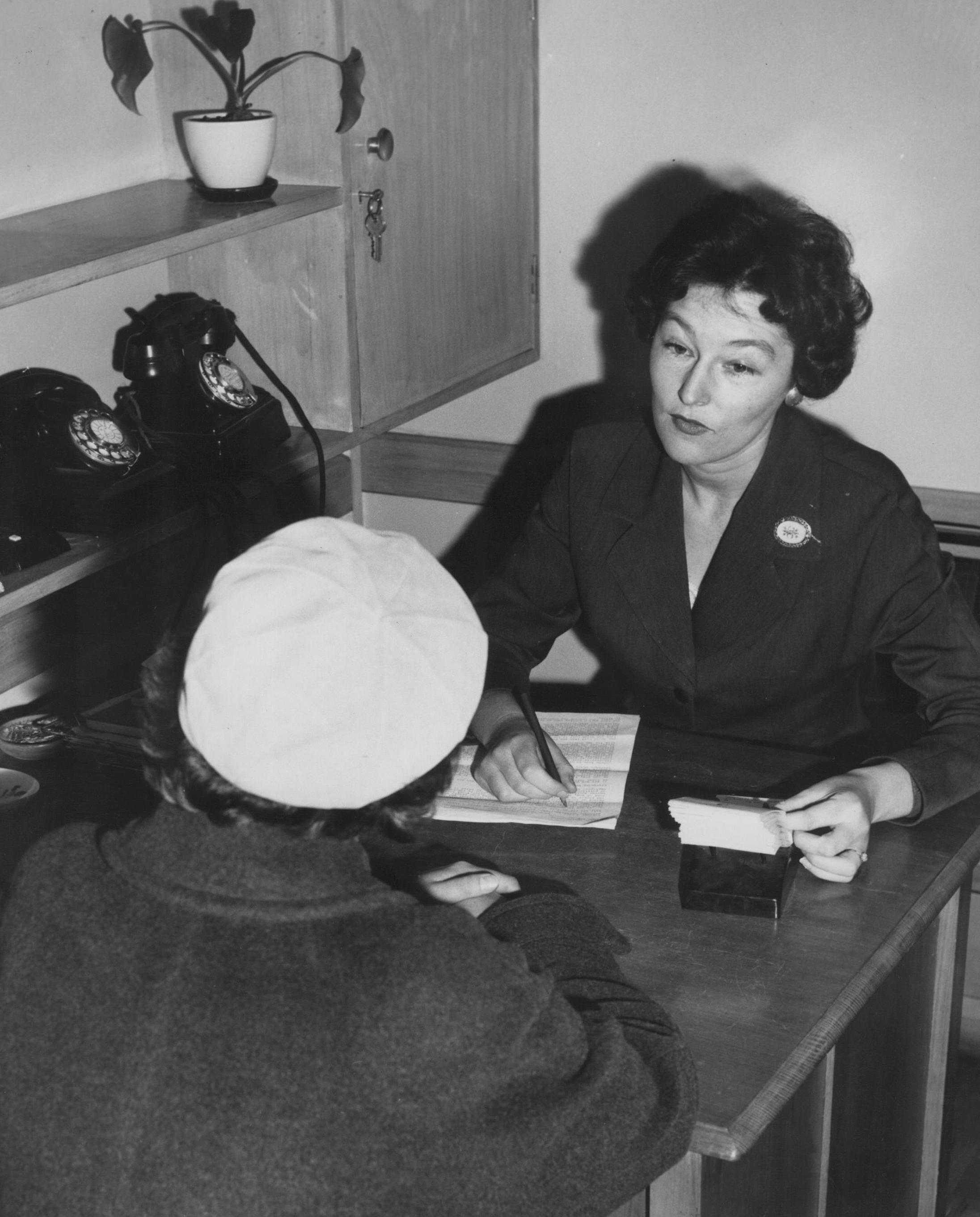 A worker meeting with a client at the Social Service Bureau where BSL's legal aid service was conducted